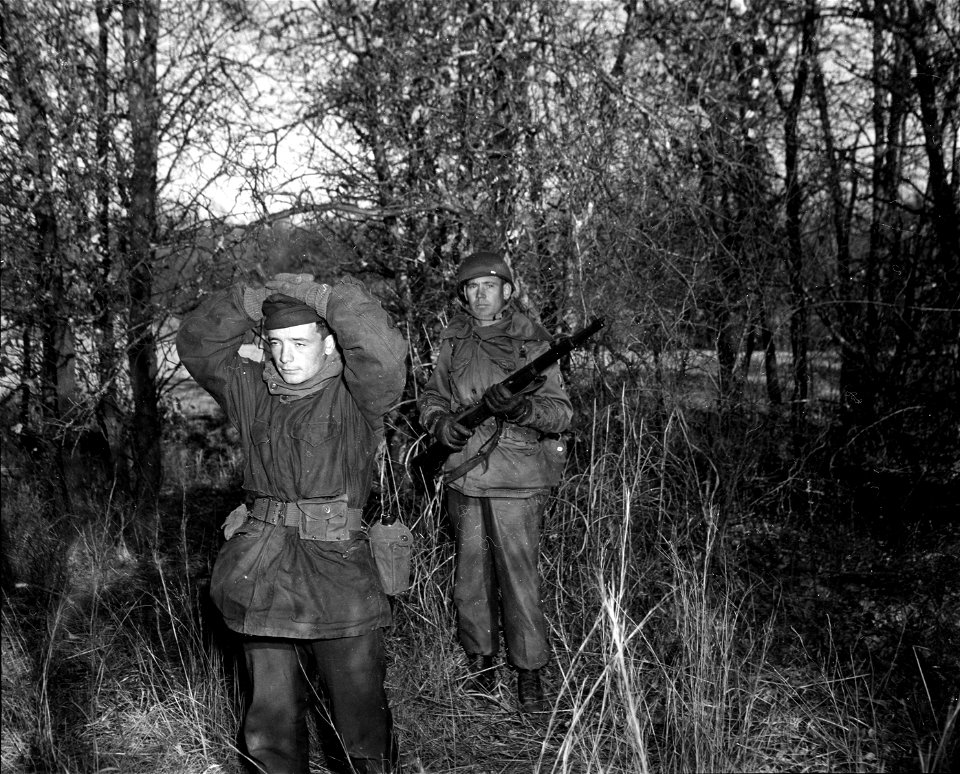 SC 364246 - Sgt. Charles H. Hague, Boerne, Texas, marches an "aggressor" prisoner back to the command post for interrogation during field maneuvers of the 46th Engr. Const. Bn. at Fort Sill, Okla.