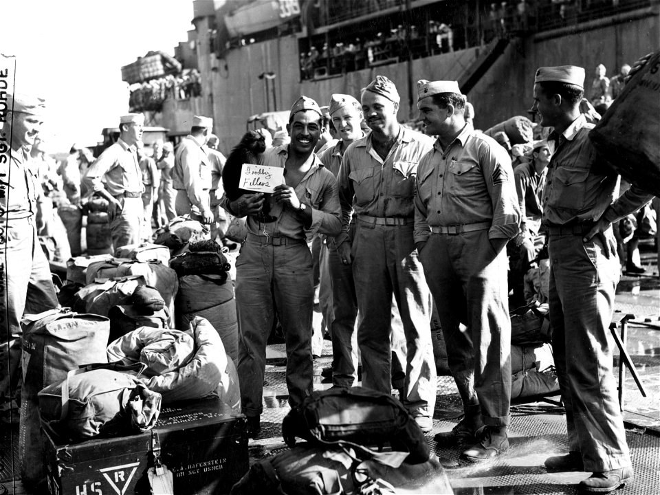 Joyous Second Division Marines, about to board ship for home after more than thirty months overseas, were not forgotten by the famed division mascot "Eight Ball", who was on hand to bid them a sorrowful goodbye.