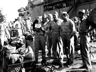 Joyous Second Division Marines, about to board ship for home after more than thirty months overseas, were not forgotten by the famed division mascot "Eight Ball", who was on hand to bid them a sorrowful goodbye.