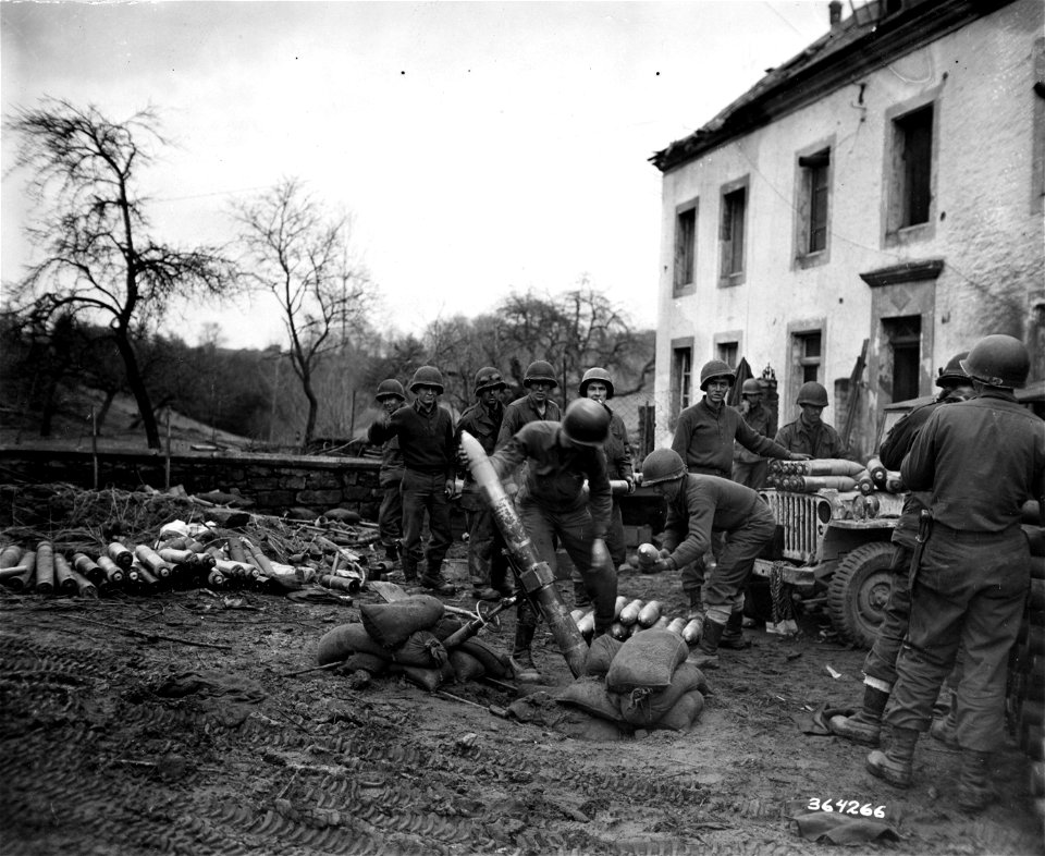 SC 364266 - Cpl. James Boyd, Riverside, Cal., and Pfc. Edgar Lsquerr(?), Springfield, Mass., operate a 4.2 mortar which is throwing smoke shells to cover the crossing of the 5th Division troops over the Sauer River.