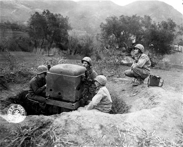 SC 396857 - L-R: Pfc. Thomas A. Barone, Pittsburg, Pa., asimuth tracker; Pfc. Jesse B. Pressley, Henderson, Ky., spotter; Pfc. R. Q. Yorkes, Youngstown, Ohio, at elevation scoope tracker; Pfc. J. J. Kreckie, Newark, N.J., at the phones.
