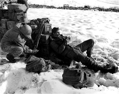 SC 396924 - Comfort is a relative thing, so Pfc. Floyd Boyd of the 339th Inf., 85th Div., sprawls out to rest and check the news, while a buddy checks a BAR. photo