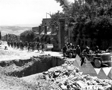 SC 184869 - An infantry company with tank traps in foreground. Barrafranca, Sicily. 19 July, 1943.
