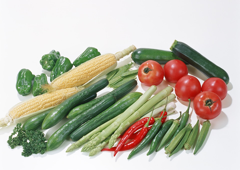 Collection of fresh green vegetables on white rustic background