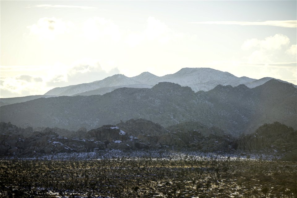 Snow over the Barker Dam parking area near sunset
