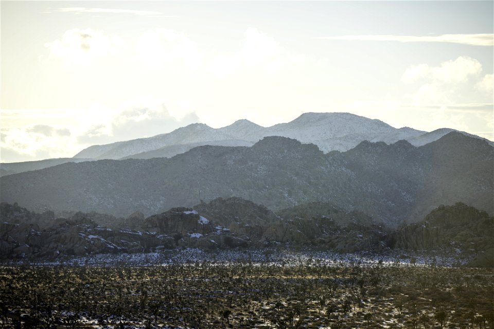 Snow over the Barker Dam parking area near sunset photo