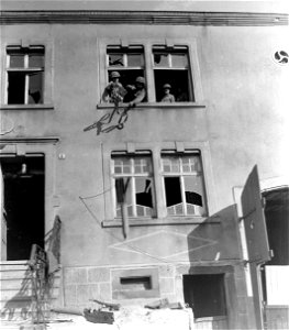 SC 335275 - Troops of the 26th Division, 3rd U.S. Army, take over a building as living quarters in Huttersdorf, Germany. photo