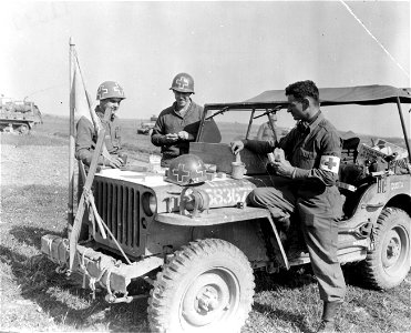 SC 396855 - Three medics eating a meal in the field somewhere in Germany. photo