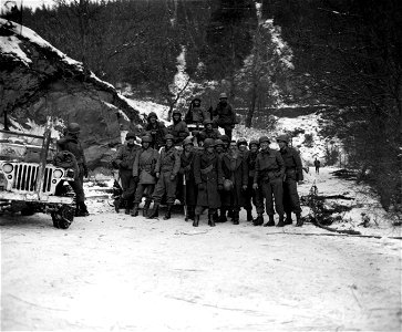 SC 335401 - Two patrols, one from the 84th Infantry Division, First U.S. Army, and the other from the 11th Armored Division, Third U.S. Army, meet at a prearranged rendezvous on the Liourthe river closing the Bulge in Belgium. photo