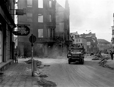 SC 335282 - Elements of the 9th Armored Division, 1st U.S. Army, roll through the streets of Limburg, Germany. 27 March, 1945.