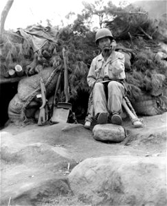 SC 348633 - An ROK soldier with the 15th Regt., 1st ROK Div., checks by phone with arty forward observer, regarding action of his battery, north of Taegu, Korea. 18 September, 1950. photo