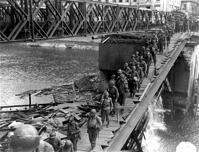 SC 270623 - Men climbing ladders to allow crossing of Doubs River in Besancon. 8 September, 1944. photo