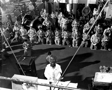 SC 348650 - Lt. John J. O'Neill (St. Paul, Minn) conducts Catholic Sunday services aboard the USS Fred Ainsworth before debarkation for Inchon, Korea. 15 September, 1950. photo