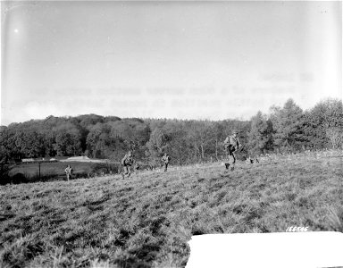 SC 166546 - Members of a 60mm mortar section moving toward battle positions in recent battle practice in Northern Ireland. 12 November, 1942.
