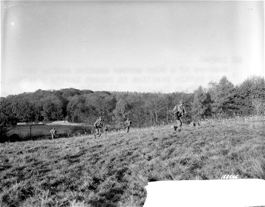 SC 166546 - Members of a 60mm mortar section moving toward battle positions in recent battle practice in Northern Ireland. 12 November, 1942. photo