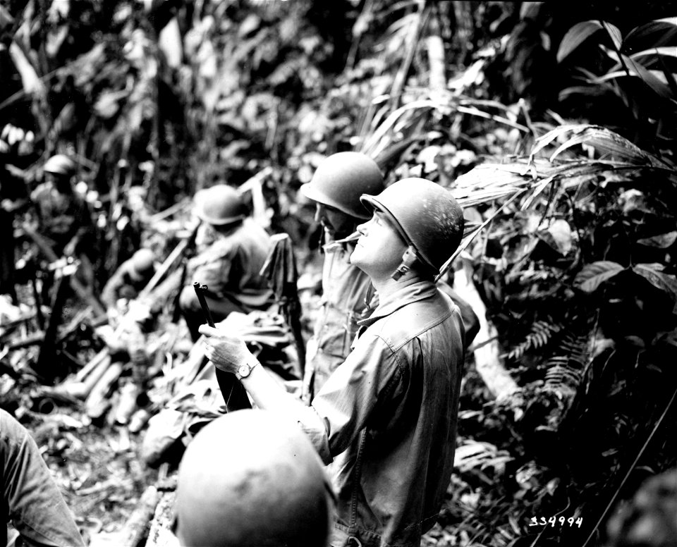 SC 334994 - Gen. J. Lawton Collins, CG of the 25th Division, scans treetops over which mortar fire must pass.