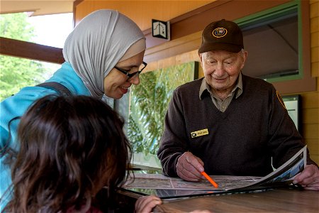 A volunteer helping a visitor photo