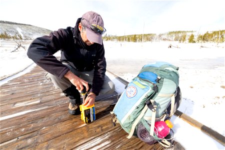 Mike Poland, USGS Scientist-in-Charge, replacing batteriest in a data logger (2) photo
