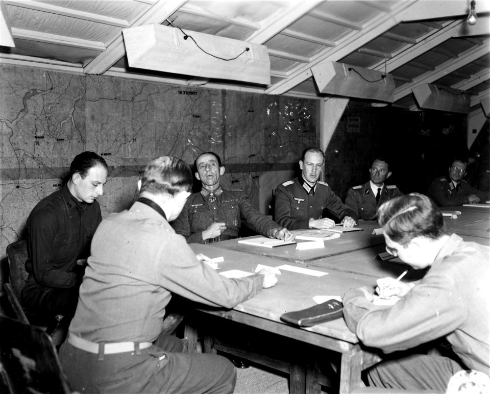 SC 329870 - With the 15th Army Group in (Florence) Italy Maj. Gen. Alfred M. Gruenther, Chief of Staff 15th Army Group, discussing the terms of surrender for the German armed forces in Italy.