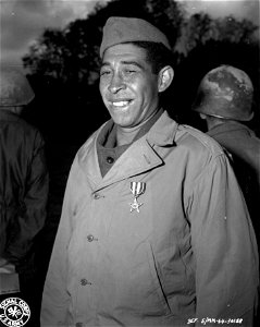 SC 196852-S - Cpl. Marcilio Juiz Pinto, San Paulo, Brazil, shown smiling after receipt of a Silver Star from Lt. Gen. Mark W. Clark, CG, Fifth Army, is the first Brazilian enlisted man to receive... photo