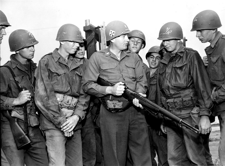 SC 334554 - Lt. Ralph C. Blow, of Company K, 8th Infantry Regiment, Fort Ord, California, is shown giving two new Army trainees, Rct. Theodore M. Hudson and Rct. Glenn E. Fisher their first lesson on the basic infantry weapons.