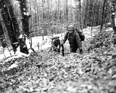 SC 271440 - Pfc. Creed Johns of Nicholasville, Kentucky, left, and Pvt. Joseph Koreal, Cleveland, Ohio, members of a pioneer squad of the 1st Battalion, 157th Regiment, 45th Division, whose job is to carry rations and supplies to soldiers in foxholes...