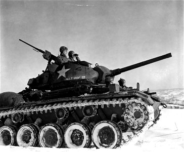 SC 198843 - In the turret of a new M-24 light tank, Sgt. Raymond Horner, left, Blanks, La., and Pvt. Romaine Mounts, Phoenix, Ariz., scan the area, somewhere on the Western Front, for enemy activity.
