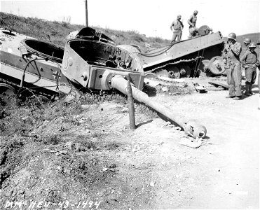 SC 171654 - Medium shot of the turret, gun and 88mm shell of a German Mark VI tank. Beja, Tunisia. 23 April, 1943. photo