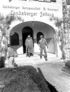 SC 335338 - Men of the 103rd Infantry Division round up all the male civilians in Landsberg, Germany, to go to the Stalag #4 concentration camp to bury political prisoners starved and burned to death by SS troops. photo