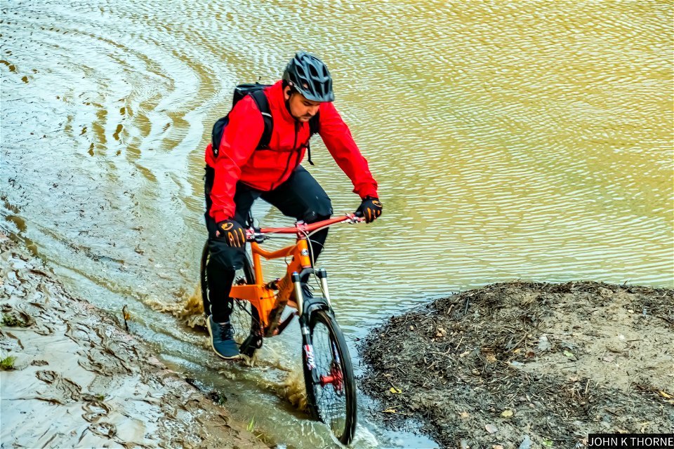 Cycling along the flooded River Medway path.