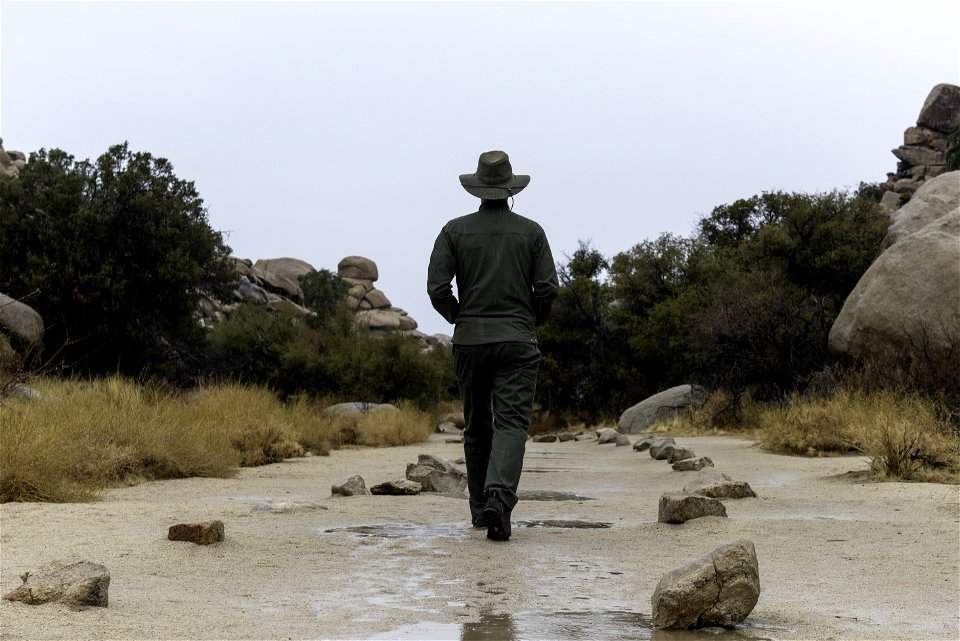 Park ranger in the rain at Barker Dam Trail photo