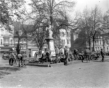 SC 330040 - Soldiers of 5th Armored Division, 9th U.S. Army, inspect pile of German knives and firearms turned in by German civilians, when town of Peine, Germany, surrendered. 10 April, 1945.