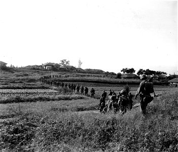 SC 348692 - Members of the 5th Marine Regt. move towards the Han River to engage in action against the North Korean forces. 18 September, 1950. photo