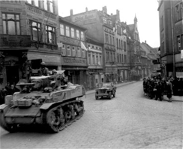 SC 336925 - Light tank of 6th Armored Division of Gen. Patton's U.S. Third Army rolling into newly-captured town of Zeitz, Germany. 16 April, 1945. photo