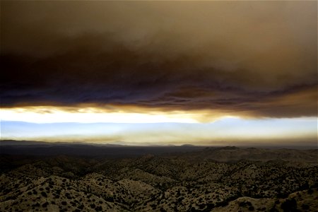 Smoke from the Apple Fire over desert hills