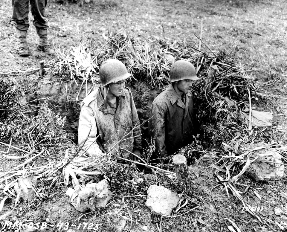SC 171619 - Pfc. Fred V. Key, Towncreek, Ala., and Glenn E. Cox, Tampa, Fla., in a German entrenchment overlooking the valley which until this morning was not safe for American troops. 7 May, 1943.