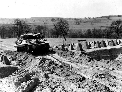 SC 336804 - Tank destroyer going through belt of dragon's teeth to assault pillboxes of the inner defenses of the Siegfried Line.
