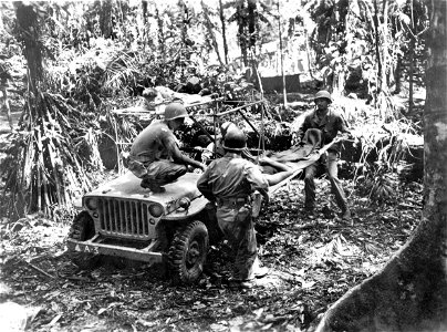 SC 334753 - Patients are removed from a jeep used as a litter carrier at a Collecting Company on Bougainville, Solomon Islands. 13 December, 1943. photo