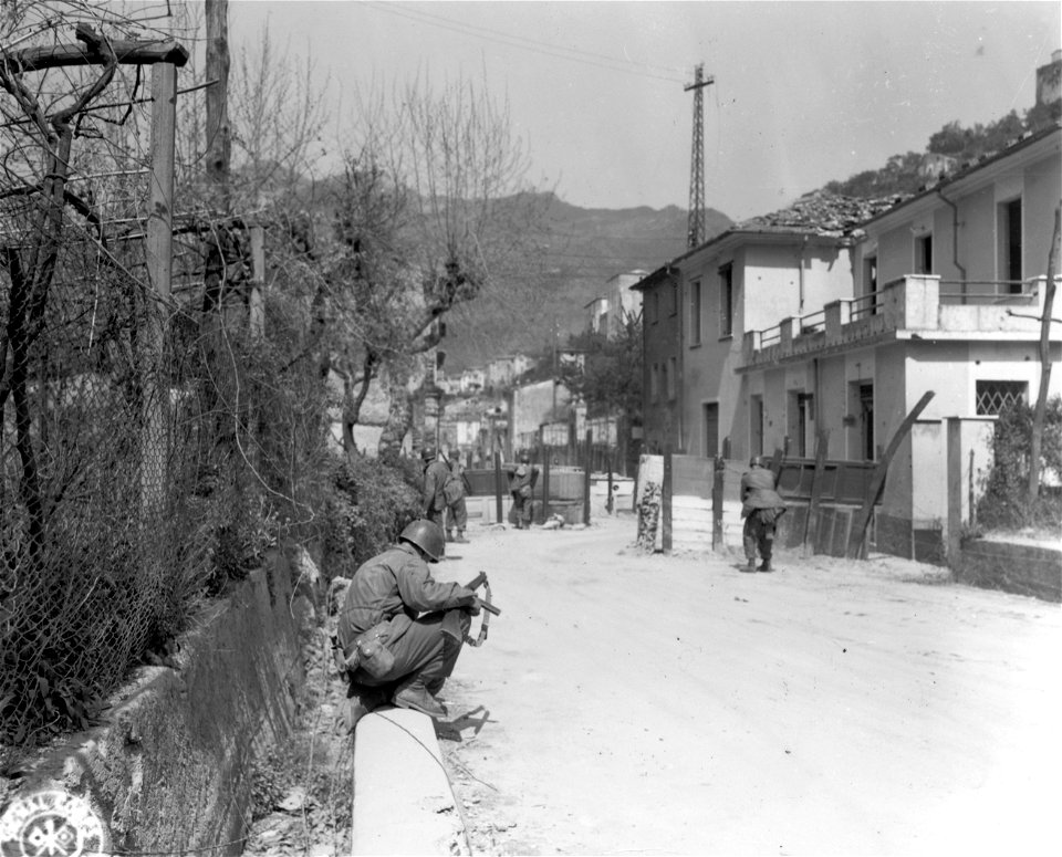 SC 337134 - On outskirts of Massa, a squad of infantrymen cautiously approach a barrier. 10 April, 1945.