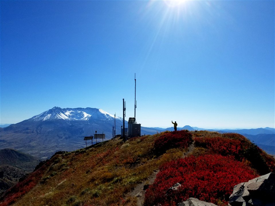 2017- GP-Staff member Orlando waves at Coldwater Mt St Helens while he is up there to maintain the radio repeater equipment.