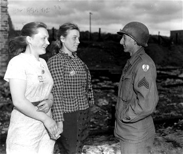 SC 405024 - Sgt. Julie Moses, Bronx, New York, N.Y., right, talks with two former Russian slave laborers in Wetzlar, Germany.