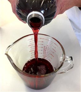 Measuring grape juice for jelly making photo