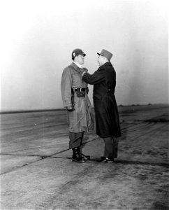 SC 364140 - Gen. Betrand pins French Silver Star on Capt. Cunningham, presented for gallantry against the Germans in 1944. Camp McCauley airstrip, Linz Sub Post, Austria.
