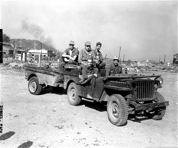 SC 348697 - Members of GHQ FEC photo team, covering the war activities in Korea, prepare to leave for the front lines to photograph offensive launched by U.S. forces against the North Korean enemy troops. photo