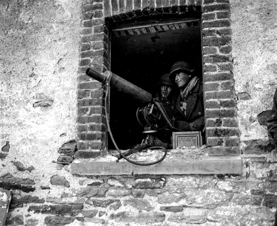 SC 364321 - Pfc. Gerald A. Cohan, 9 Shaw Ave., Newark, N.J., mans a .30 caliber machine gun covering approaches to Salmchateau, as the 75th Division takes the town.