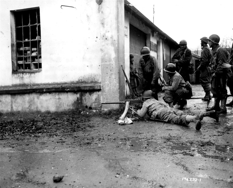 SC 196321 - French Commando fires 30 caliber machine-gun at German positions on the road to Belfort, as his compatriots watch. 20 November, 1944.