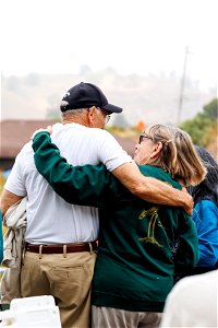 Attendees embrace during event activities photo