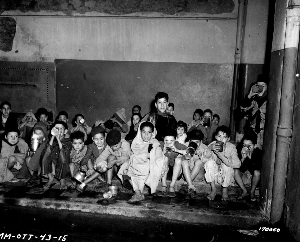 SC 170060 - Arabic children drinking their daily ration of milk at a bombed school in North Africa.