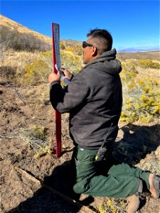 A BLM Fire employee installs new markers