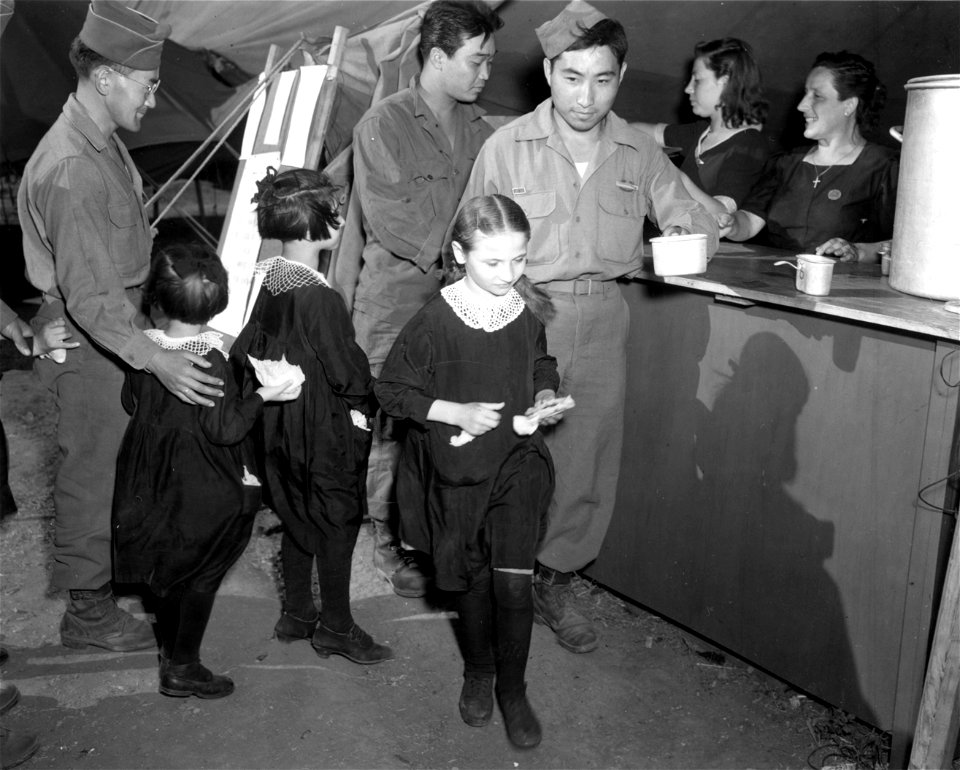 SC 329874 - Pfc. Jone Roshiba, Co. I., 442nd Inf. Regt., adopted a little orphan, one of the group from the St. Joseph's Orphanage that attended the 4th of July party at the Red Cross...